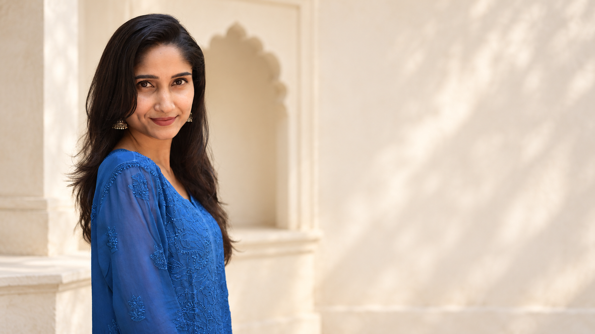 AI-assisted courtyard editorial based on the real House of Murri cobalt-blue kurtha photograph